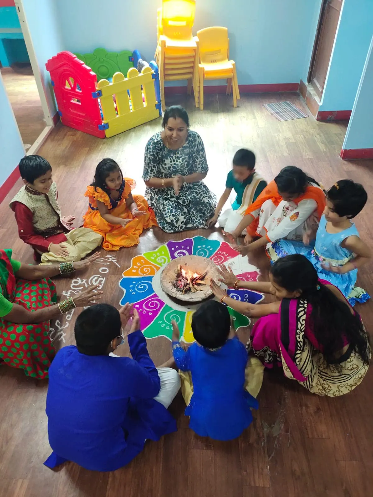 A teacher and children seated in a circle around a rangoli in an AbilityElevate classroom