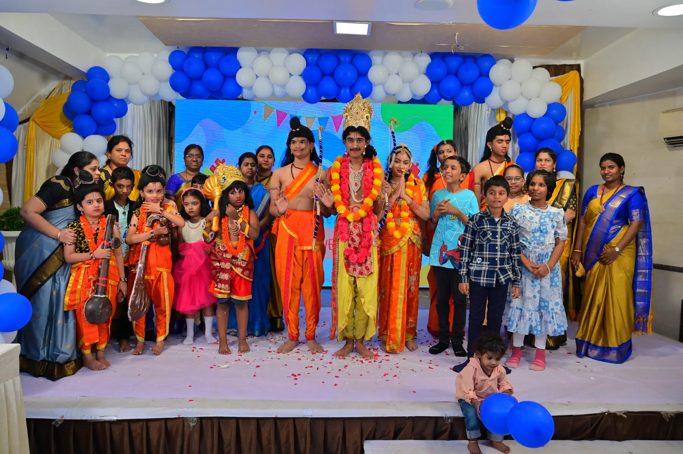Children and teachers of AbilityElevate together on stage in costume at a school celebration